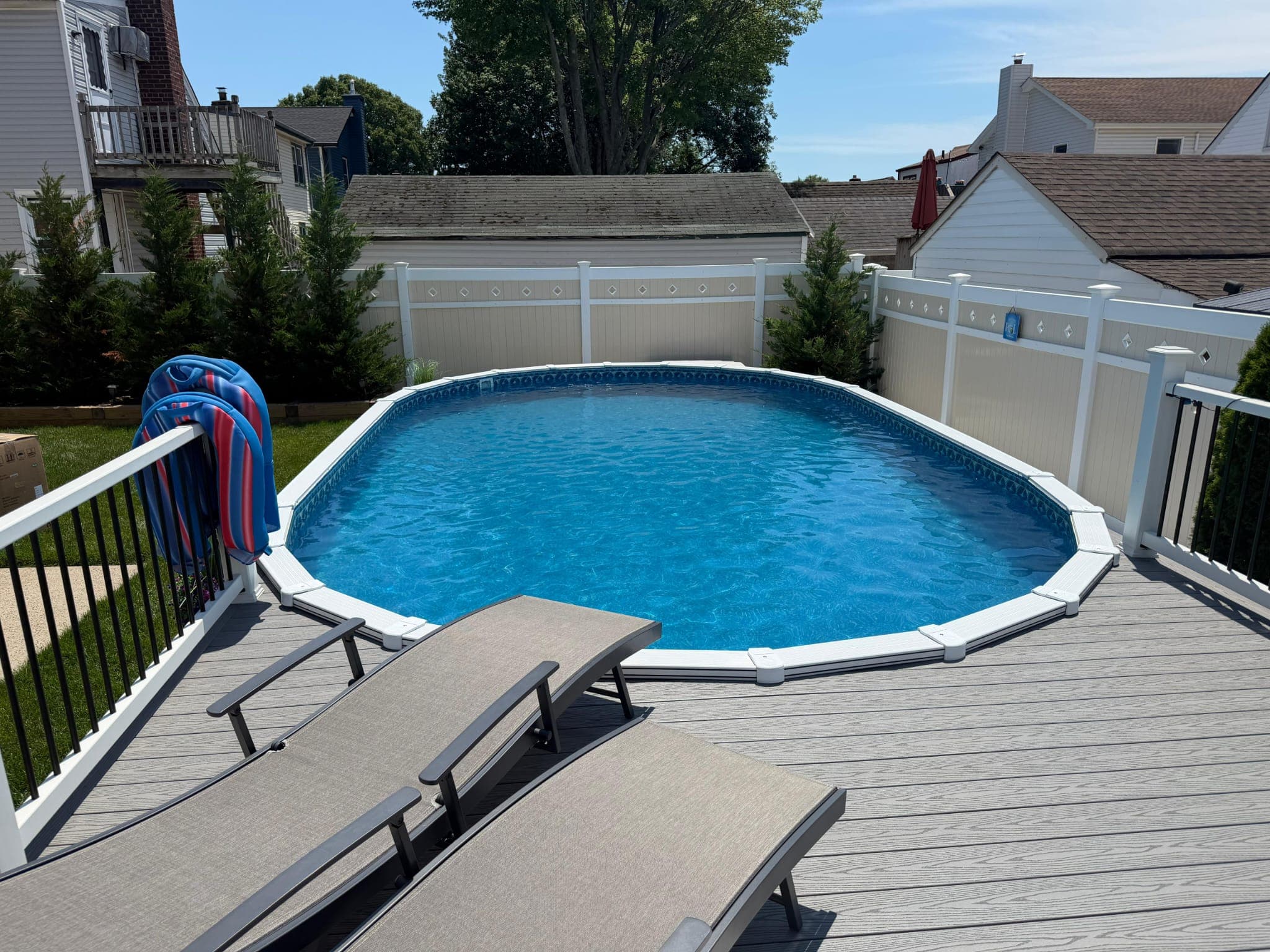 Franklin Pool Service completed installation: semi-inground pool set in a residential yard